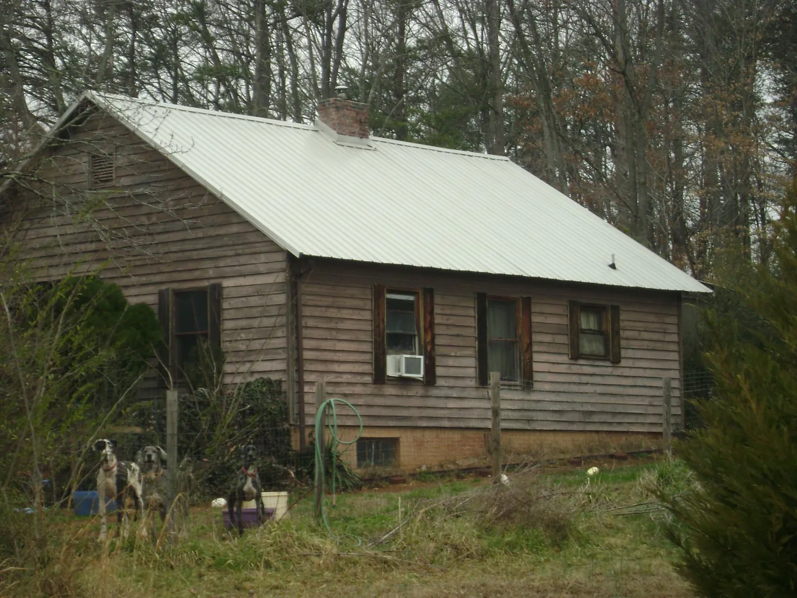 White metal roof on an old wood sided farmhouse, from a Metal Roof Installation job in Lumpkin